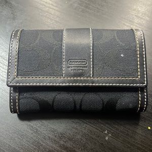 Black hand held coach wallet